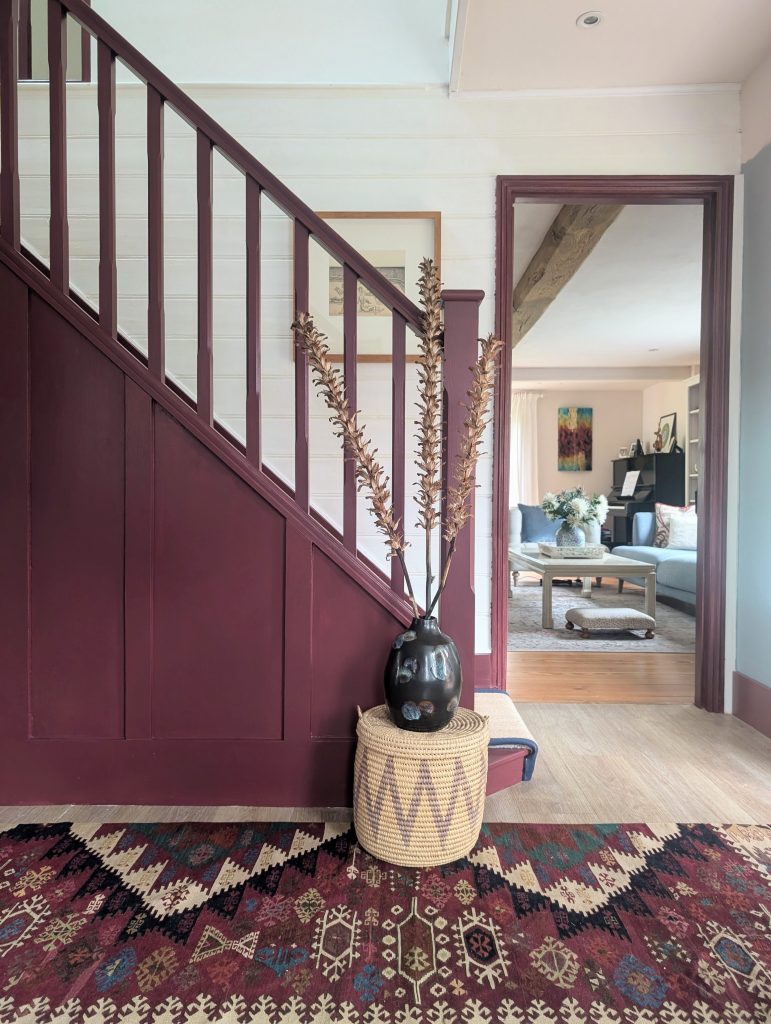 Elegant stair case in Essex painted in Farrow & Ball burgundy